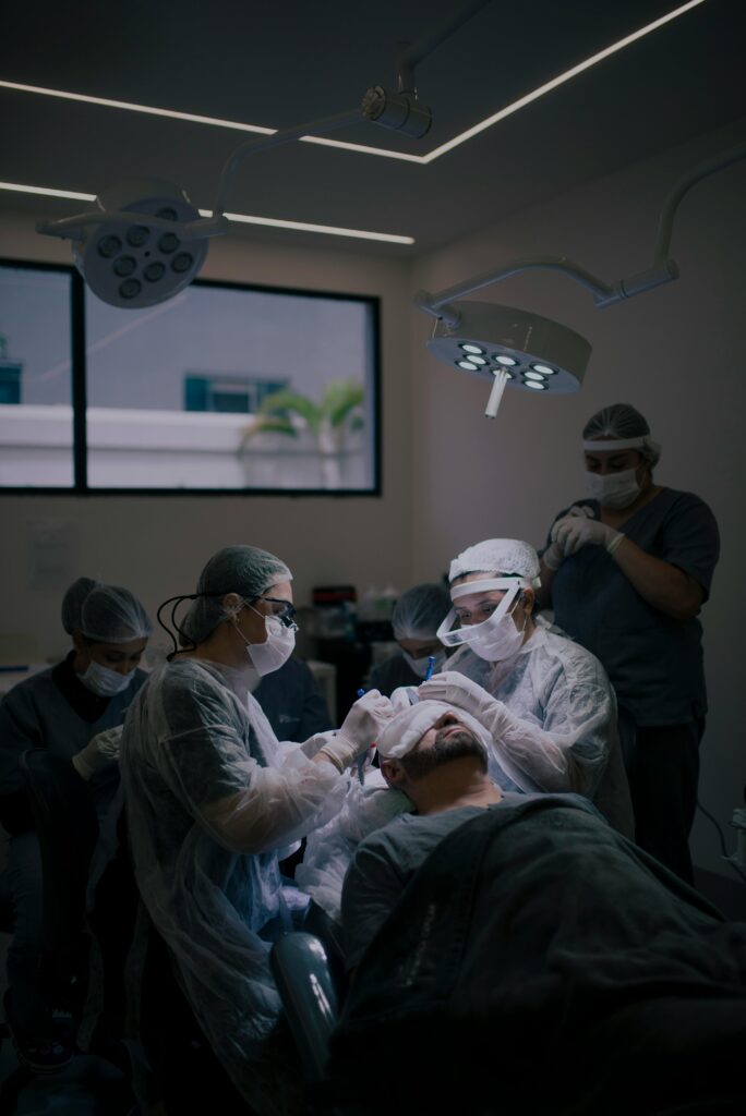 Surgeons conduct a hair transplant procedure in a modern operating room.