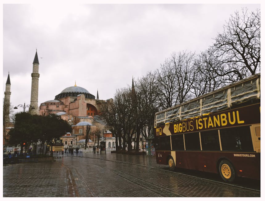 Scenic view of Hagia Sophia and tourist bus in rainy Istanbul street.