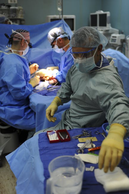 Team of surgeons in a hospital operating room conducting a surgery.