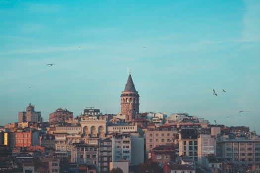 Beautiful cityscape featuring the iconic Galata Tower under a blue sky in Istanbul.